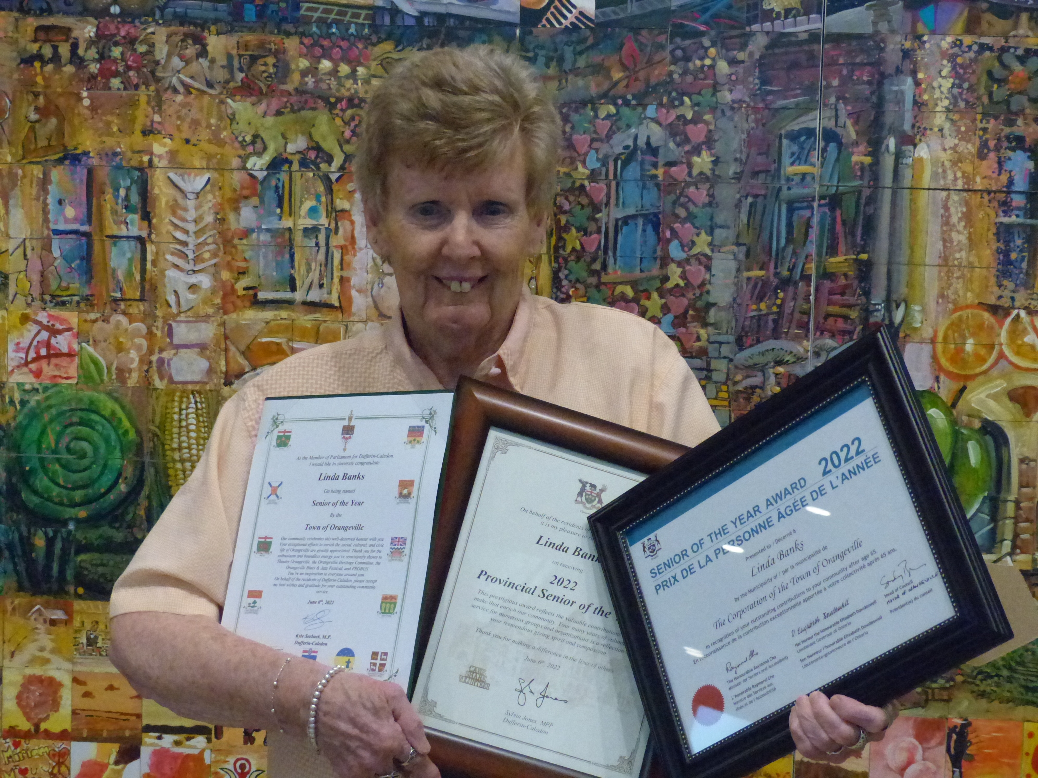 Linda Banks holds three certificates after being named Ontario's Senior of the Year